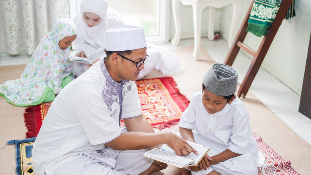 Asian Muslim families read the quran after prayers