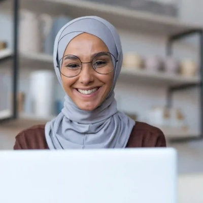 imresizer-close-up-photo-of-young-beautiful-arab-woman-in-hijab-and-glasses-working-at-home-sitting-in-kitchen